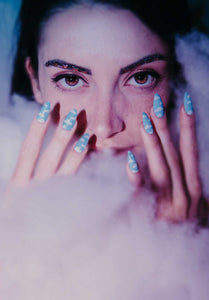 girl wearing light blue press on nails with butterfly glitter makeup