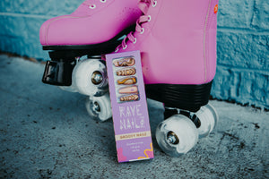 pink rollerskates and a box of 70s throwback long press on nails in a coffin shape