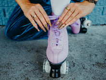 Load image into Gallery viewer, girl wearing blue velvet and cute trippy heart press on nails typing her roller skates
