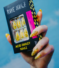 Load image into Gallery viewer, wearing the Acid Smiley press on nails and holding a box of yellow dripping smiley face nails
