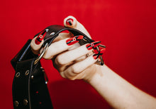 Load image into Gallery viewer, hand wearing fake nails holding a black leather harness
