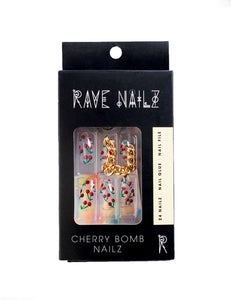 box of cherry bomb press on nails that are almond shaped and have tiny cherries